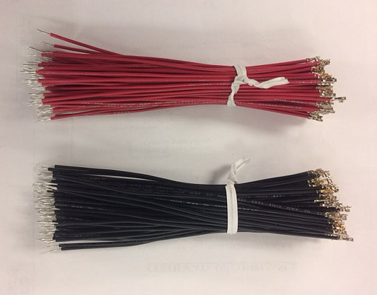Photo of black and red bundles of UL1007 wire, cut, stripped, crimped, tin dipped and ready for shipping.