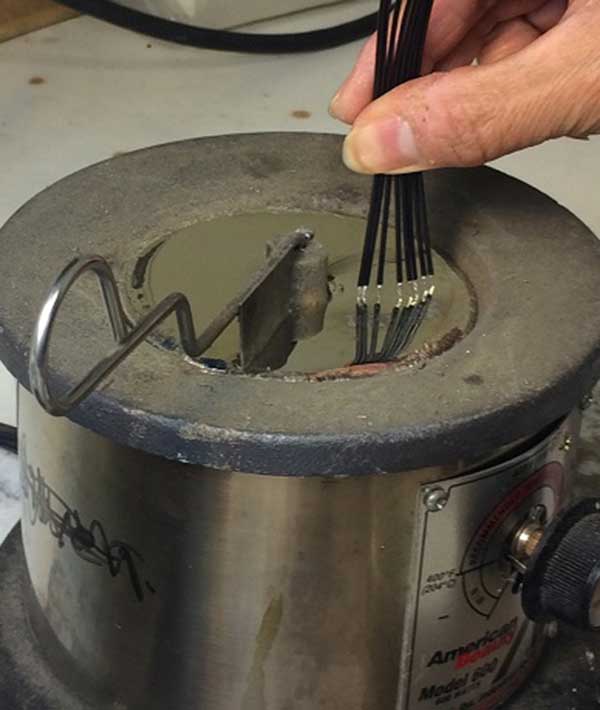 Photo of UL1007-26-7 hook up wire being tin dipped.