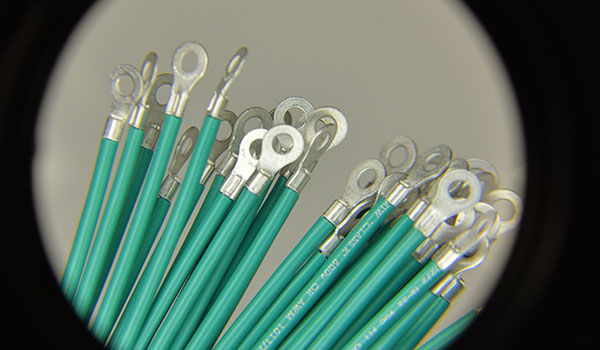 Photo of magnified wires with soldered eyelets